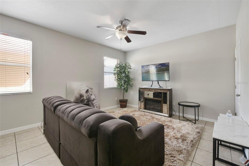 1209 Seburn Road Apopka, FL 32703 - Photo 4 of 25 a living room with furniture and a fireplace