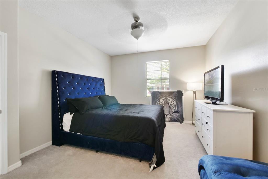 1209 Seburn Road Apopka, FL 32703 - Photo 9 of 25 a bedroom with a bed and a flat tv screen on the dresser