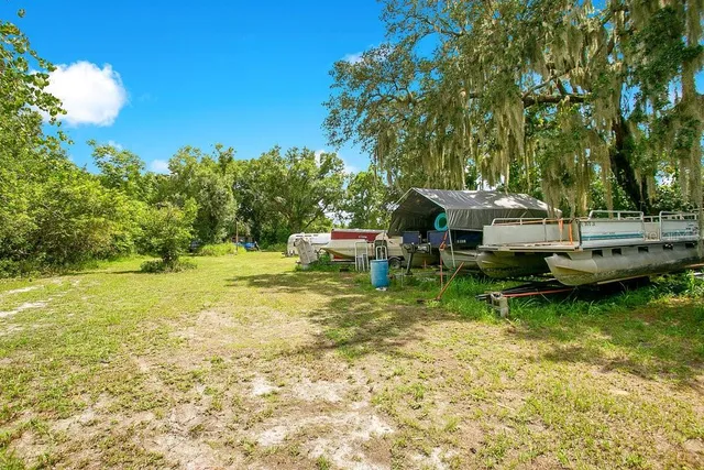 a backyard of a house with table and chairs
