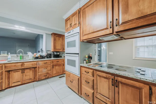 a kitchen with stainless steel appliances granite countertop a sink and cabinets