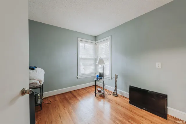 a view of kitchen with stainless steel appliances granite countertop a refrigerator and a stove