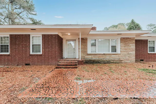front view of a house with a yard