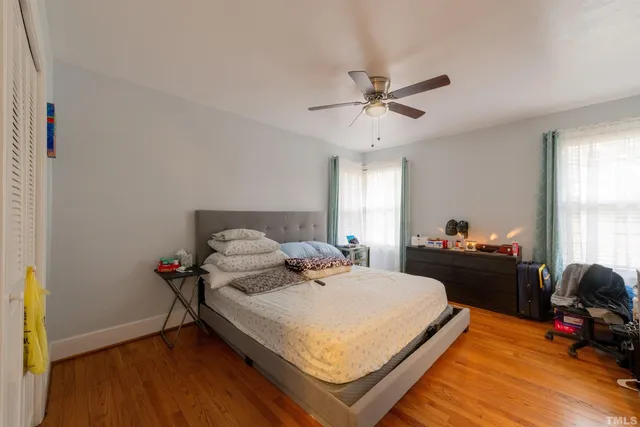 a bedroom with a bed and a chandelier