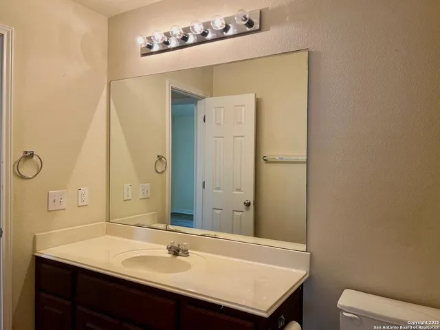 a view of a room with a large windows and refrigerator