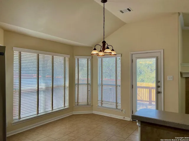 a view of a deck with a table and chairs