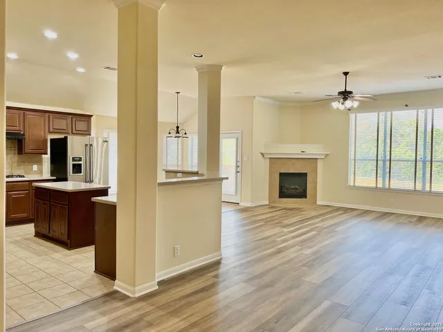 a view of a hallway with wooden floor and a fireplace
