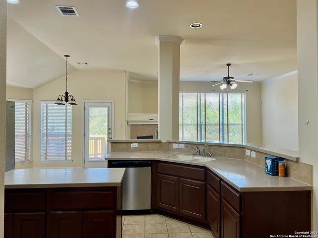 a kitchen with stainless steel appliances kitchen island granite countertop a sink stove and refrigerator
