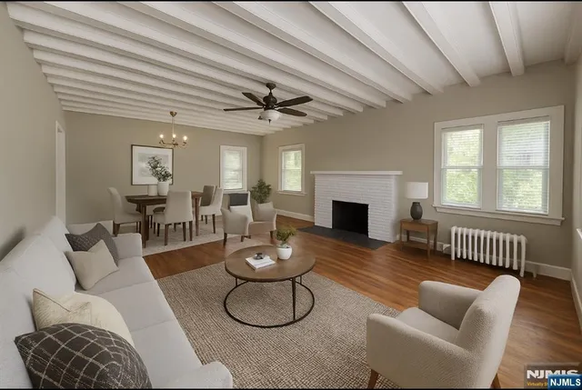 a living room with furniture a fireplace and wooden floor