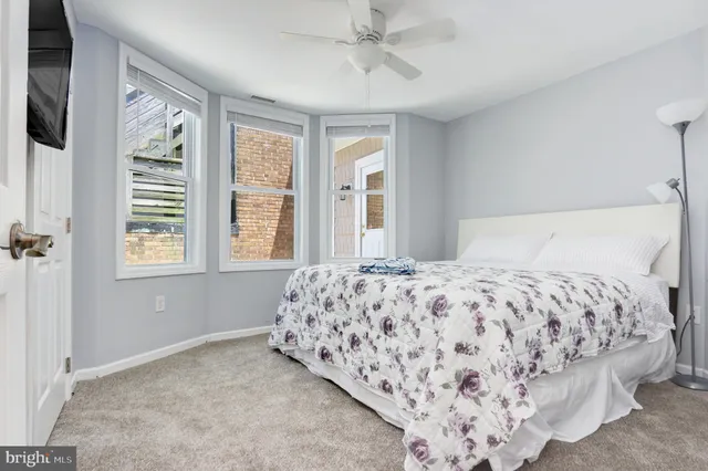 a bedroom with a large bed and a window