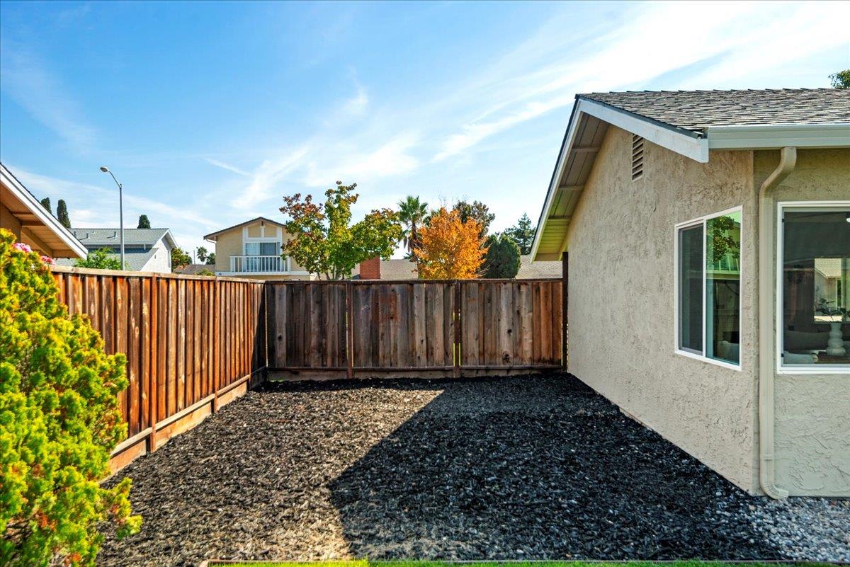8261 Olympic Court Newark, CA 94560 - Photo 12 of 40 a view of a pathway gate with wooden fence