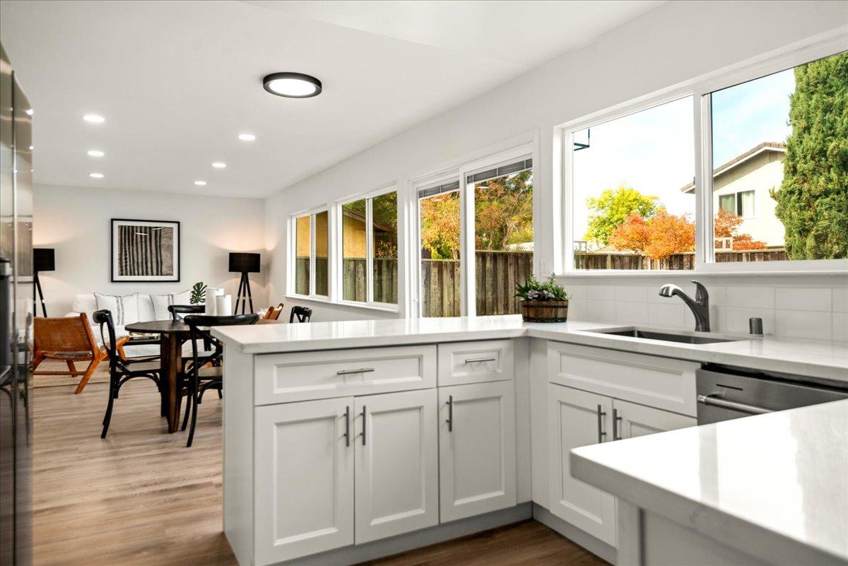 8261 Olympic Court Newark, CA 94560 - Photo 23 of 40 a kitchen with sink cabinets and dining table