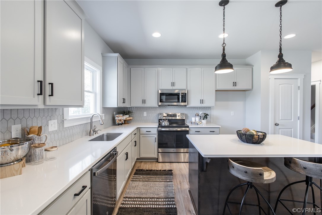 13140 Beach Road Chesterfield, VA 23832 - Photo 13 of 34 a kitchen with stainless steel appliances a stove a sink a window and cabinets