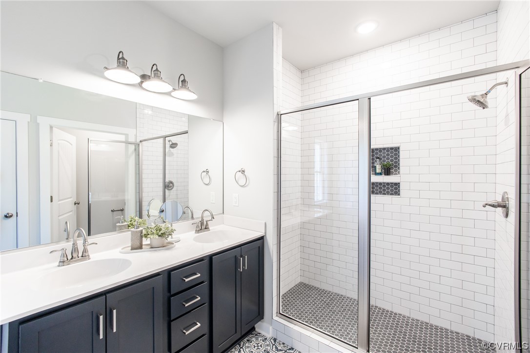13140 Beach Road Chesterfield, VA 23832 - Photo 21 of 34 a bathroom with a double vanity sink mirror and shower