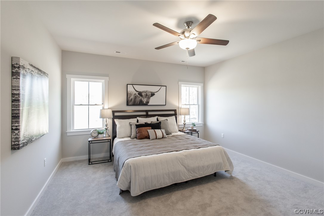 13140 Beach Road Chesterfield, VA 23832 - Photo 3 of 34 a bedroom with a bed and a chandelier