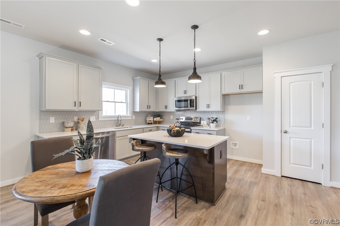 13140 Beach Road Chesterfield, VA 23832 - Photo 10 of 34 a kitchen with kitchen island a white counter space a sink appliances and cabinets