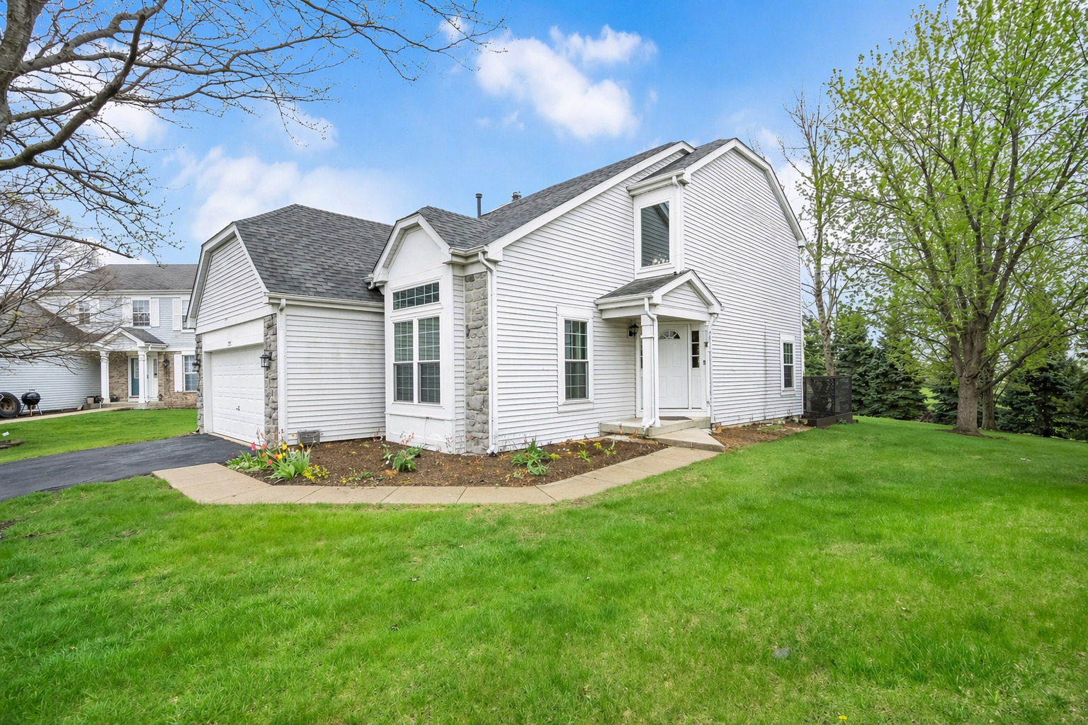 a front view of a house with a garden