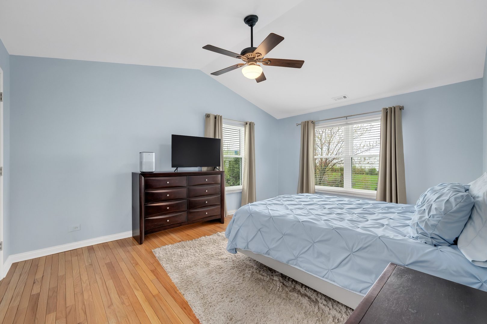 772 Rebecca Lane Bolingbrook, IL 60440 - Photo 17 of 27 a bedroom with a bed and a flat screen tv
