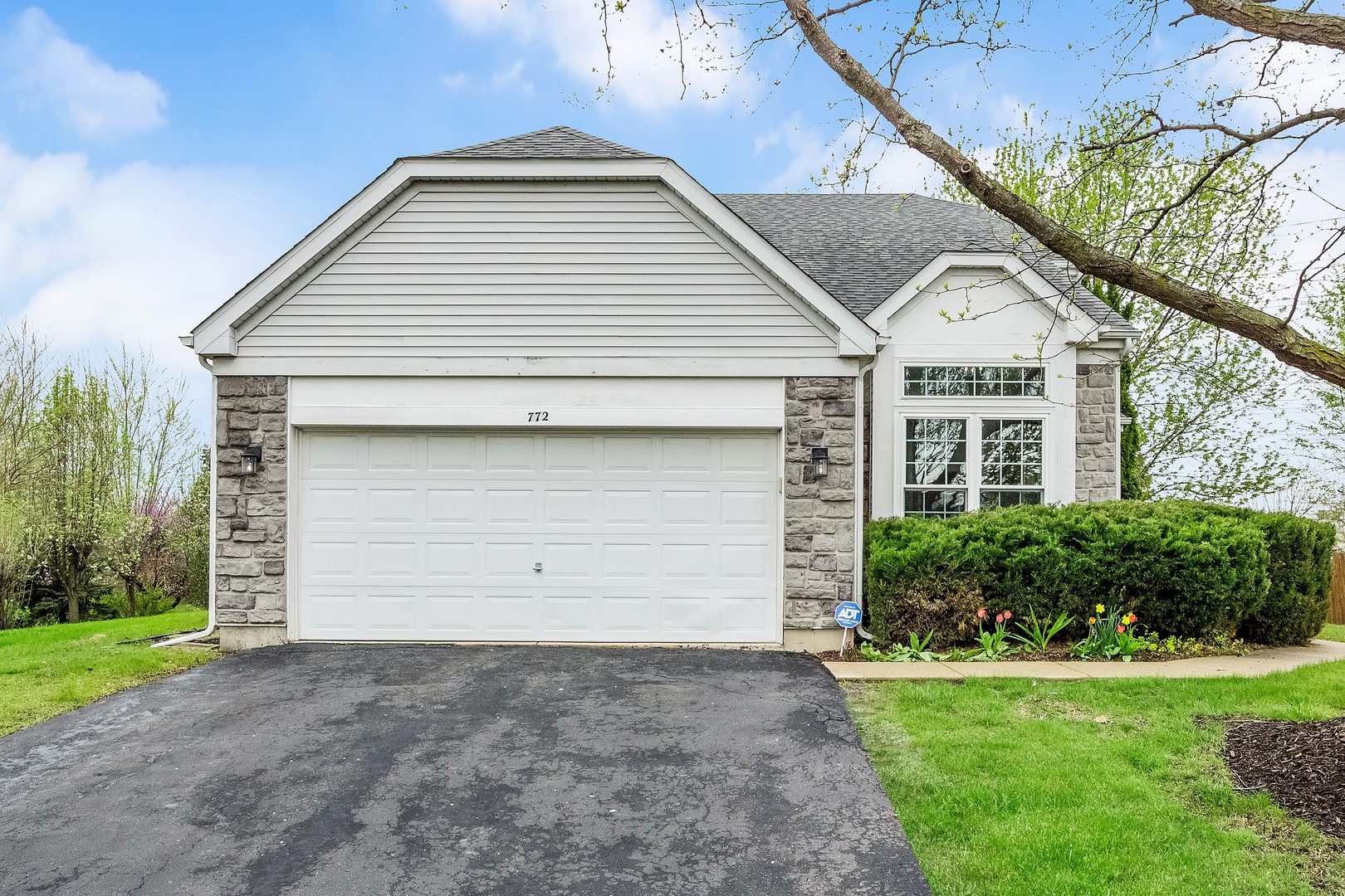 772 Rebecca Lane Bolingbrook, IL 60440 - Photo 3 of 27 a front view of a house with a yard and garage
