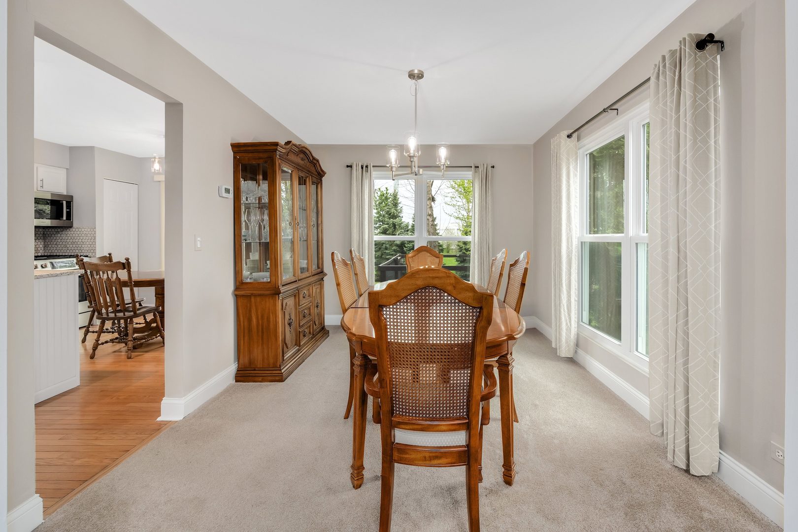 772 Rebecca Lane Bolingbrook, IL 60440 - Photo 7 of 27 a dining room with furniture window wooden floor and a chandelier