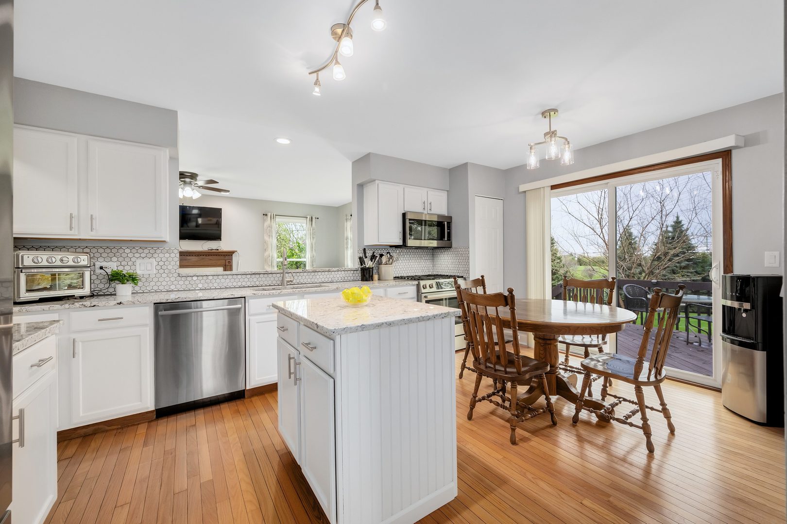 772 Rebecca Lane Bolingbrook, IL 60440 - Photo 8 of 27 a open kitchen with stainless steel appliances granite countertop a stove top oven a sink dishwasher a dining table and chairs with wooden floor
