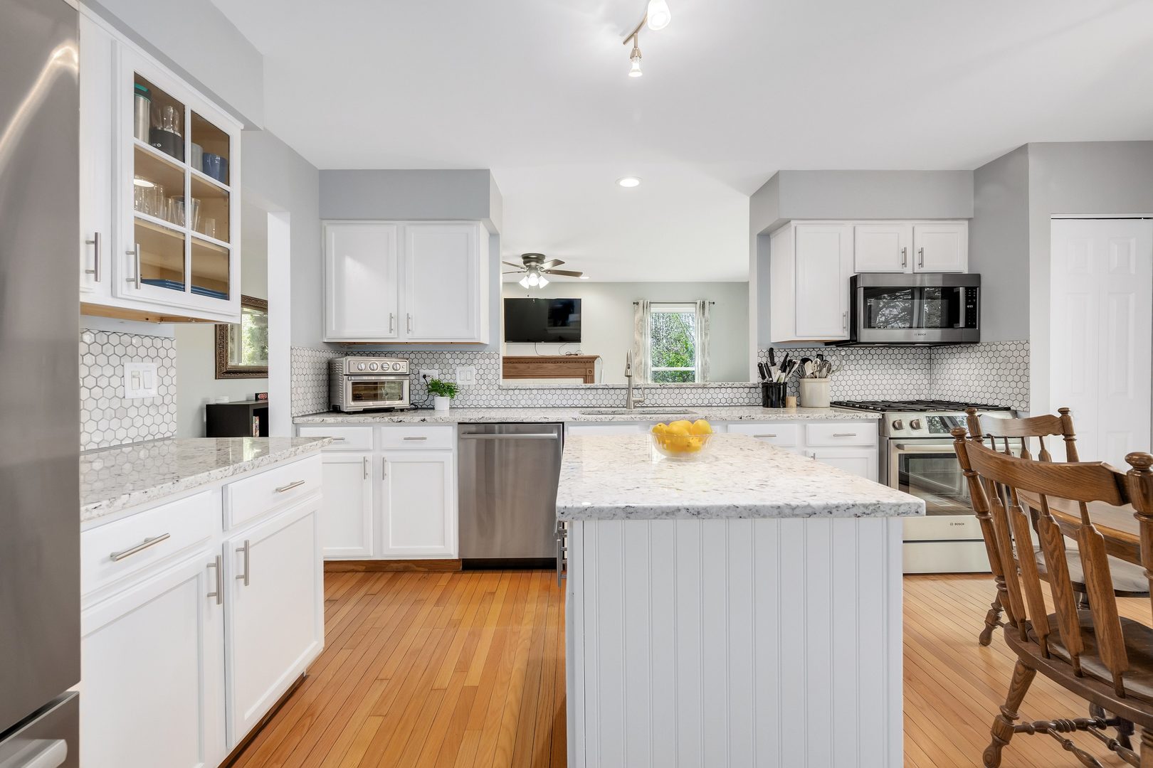 772 Rebecca Lane Bolingbrook, IL 60440 - Photo 10 of 27 a kitchen with stainless steel appliances granite countertop a refrigerator a stove top oven a sink dishwasher and white cabinets with wooden floor