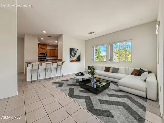 a living room with fireplace furniture and a flat screen tv