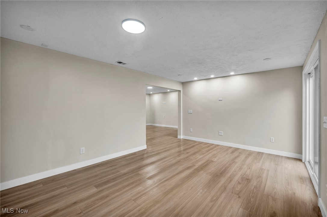 614 Weller Road Elyria, OH 44035 - Photo 19 of 39 Empty room with light wood-style floors and recessed lighting