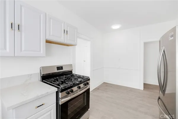 a stove top oven sitting inside of a kitchen