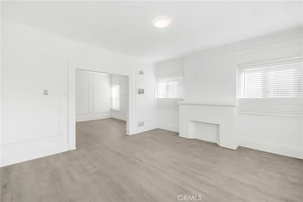 an empty room with a empty space and windows