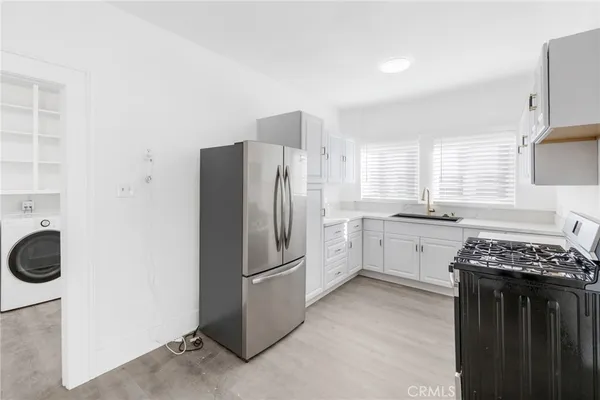 a kitchen with a refrigerator and a sink