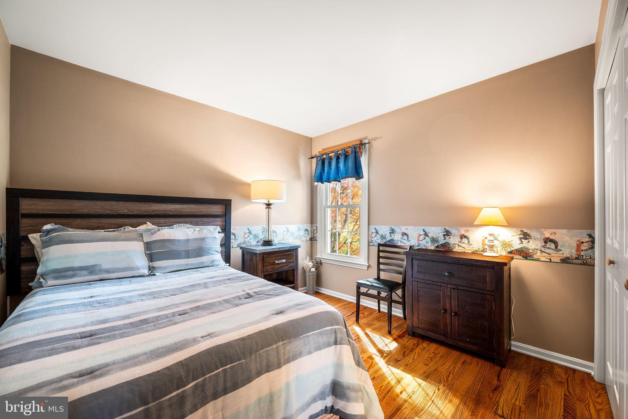 4 Pierce Lane Downingtown, PA 19335 - Photo 26 of 43 a bedroom with a bed and wooden floor