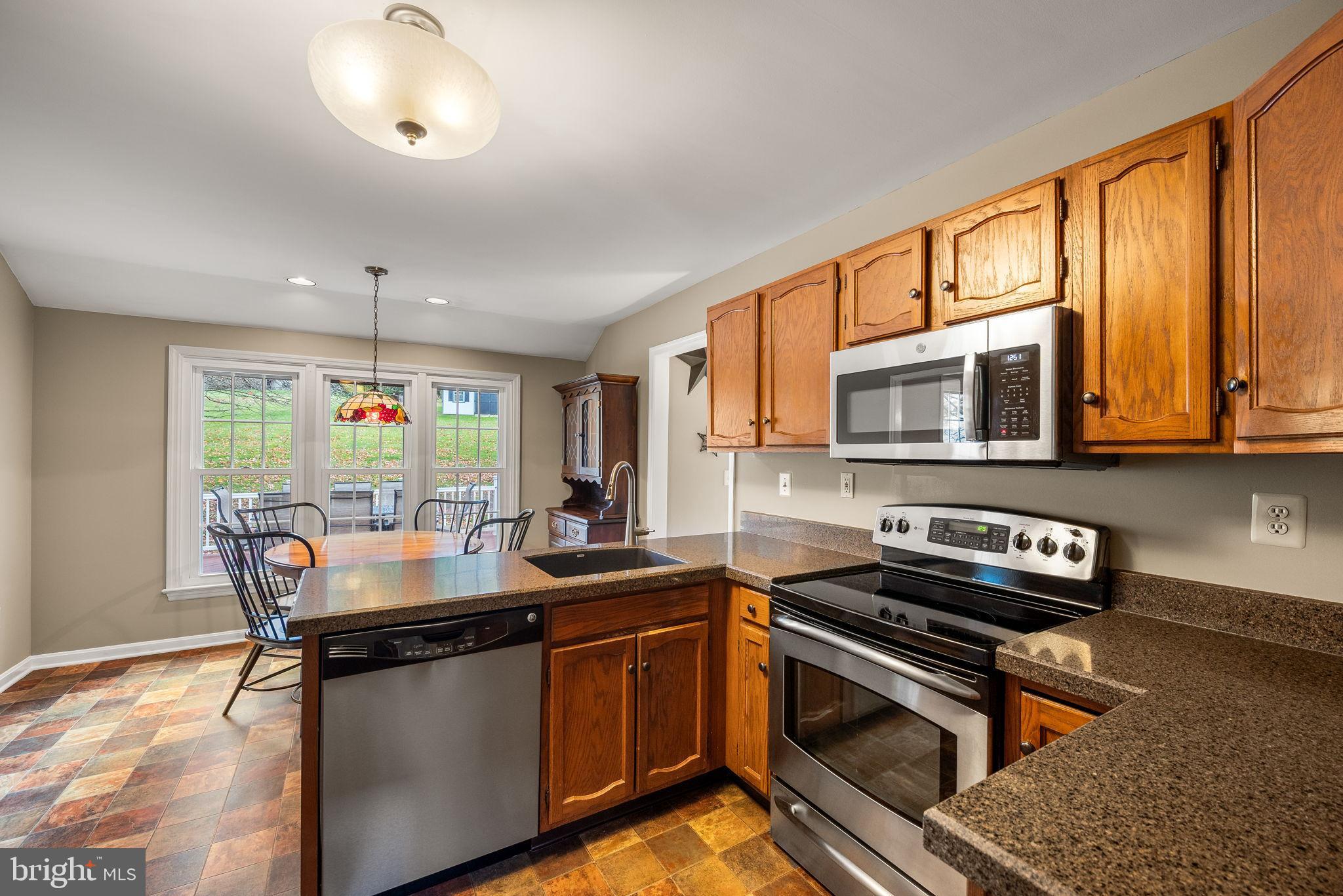 4 Pierce Lane Downingtown, PA 19335 - Photo 4 of 43 a kitchen with a stove a sink and a microwave