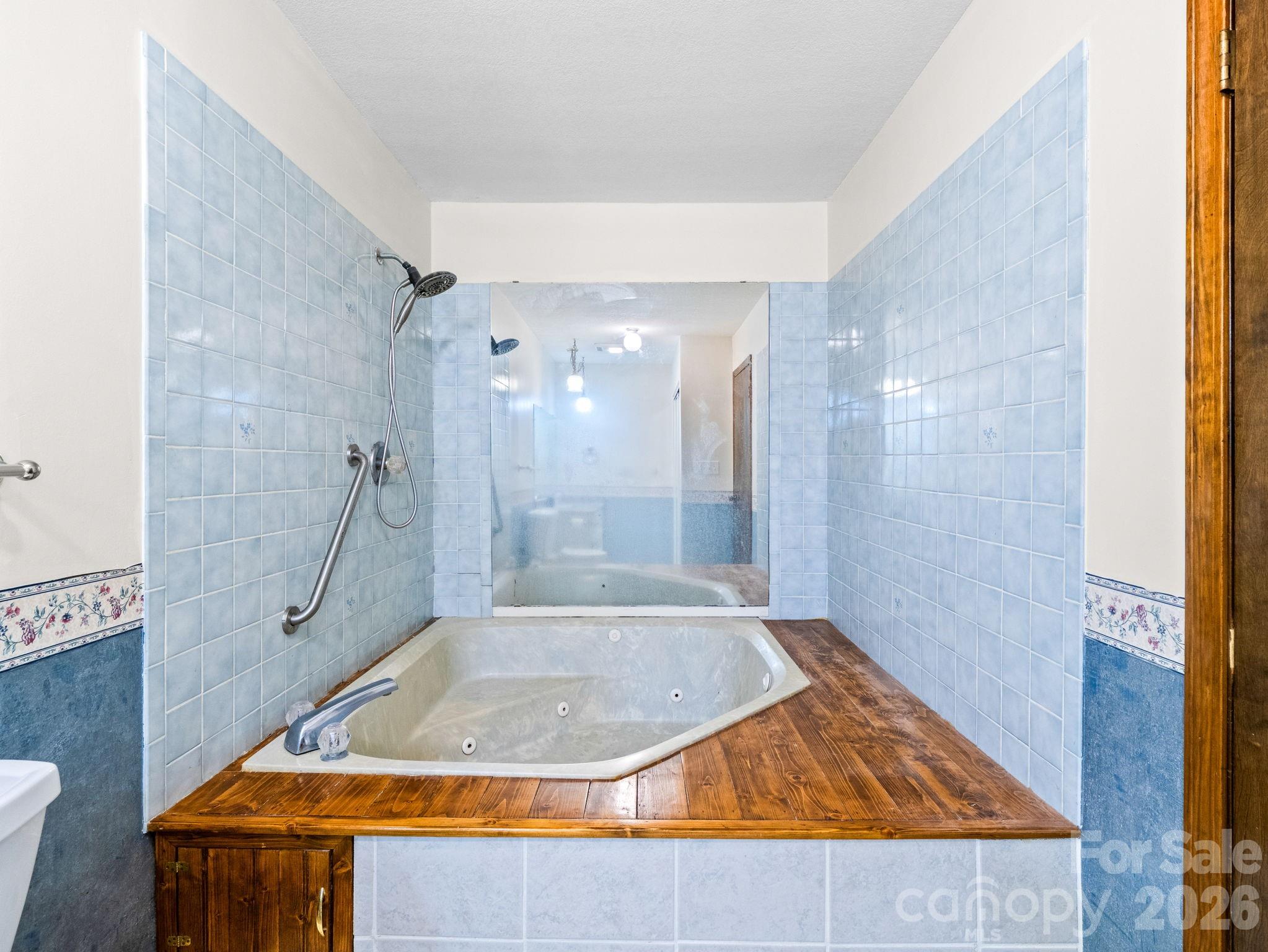 111 Buckeye Road Lake Lure, NC 28746 - Photo 14 of 48 a bathroom with a granite countertop sink a shower and a mirror