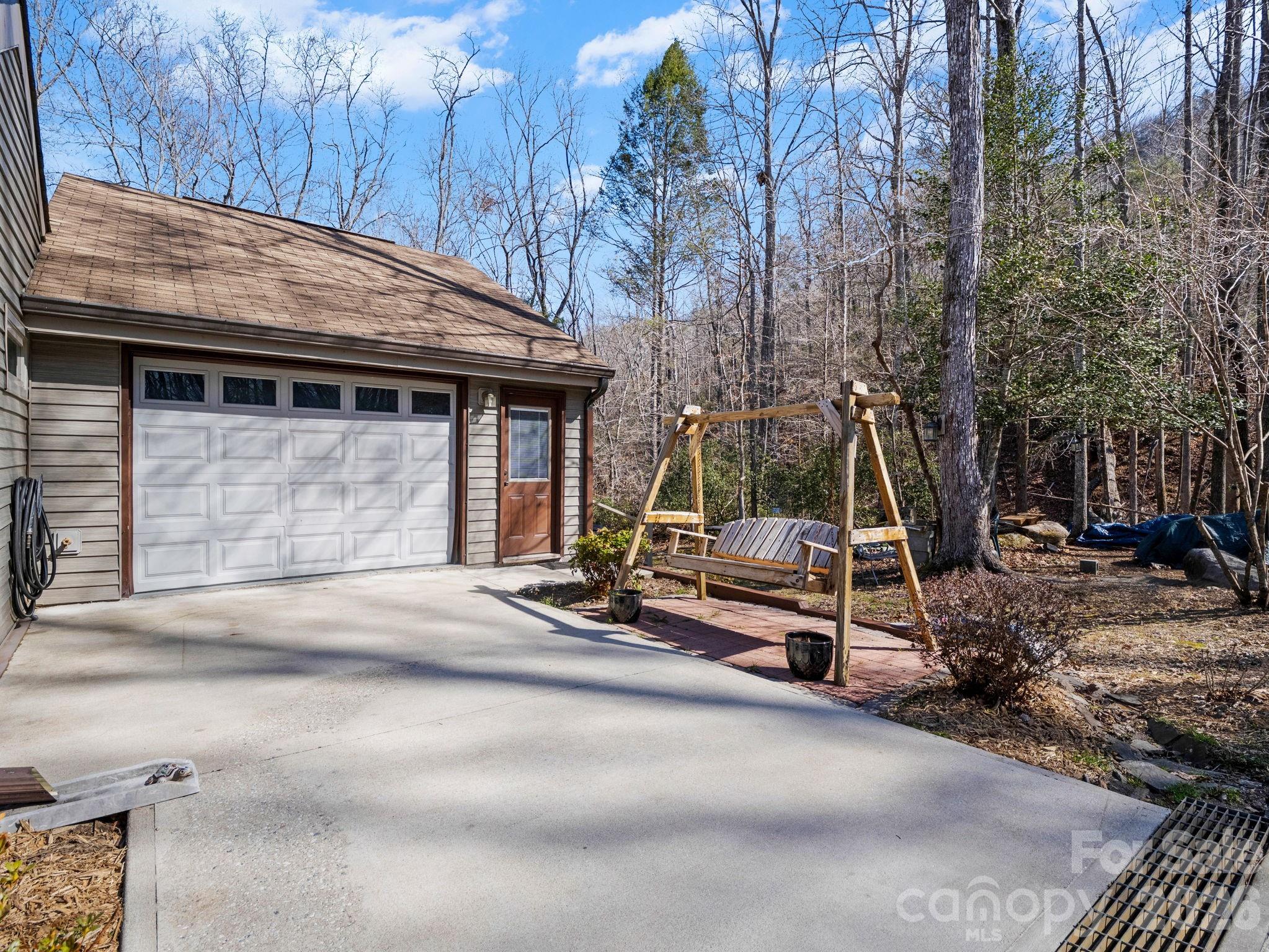 111 Buckeye Road Lake Lure, NC 28746 - Photo 29 of 48 a view of a house with backyard and sitting area