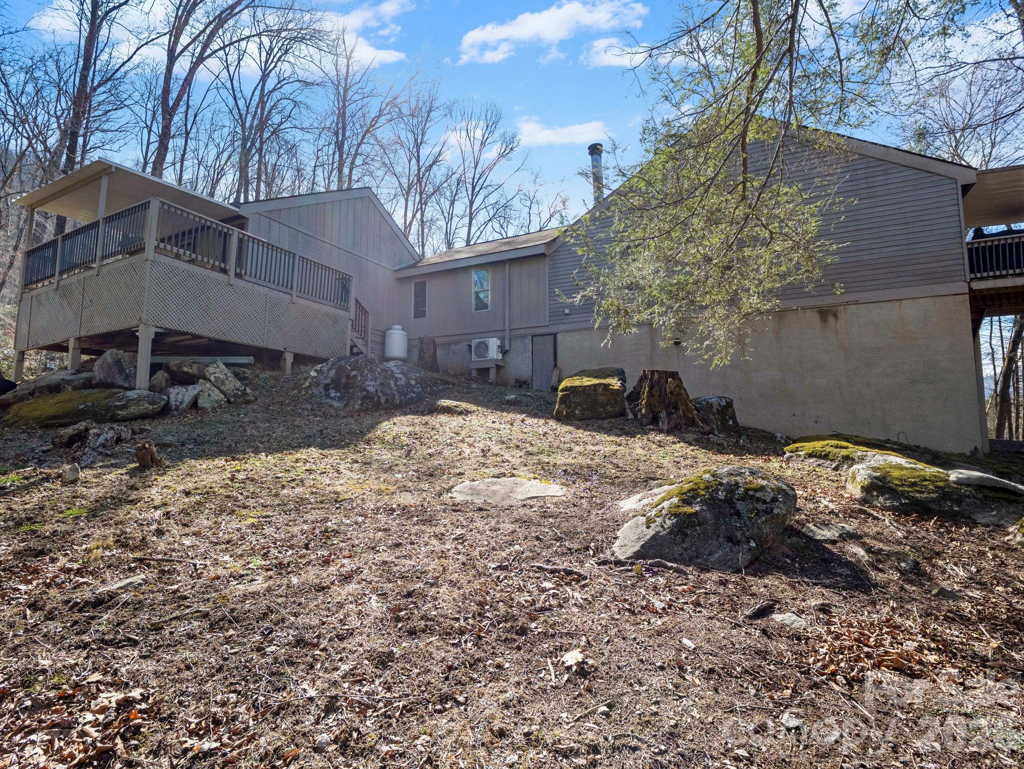 111 Buckeye Road Lake Lure, NC 28746 - Photo 36 of 48 a backyard of a house with a large tree
