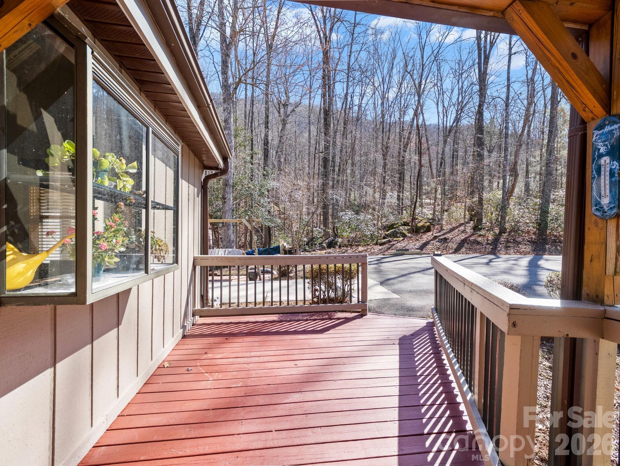 111 Buckeye Road Lake Lure, NC 28746 - Photo 5 of 48 a view of a porch with wooden floor and furniture