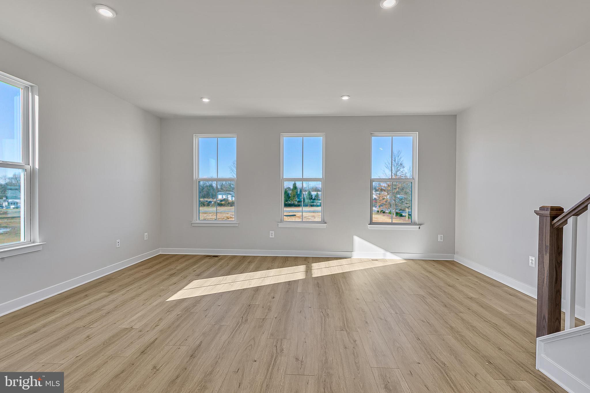 64 F Oasis Avenue Ranson, WV 25438 - Photo 23 of 39 an empty room with wooden floor and windows