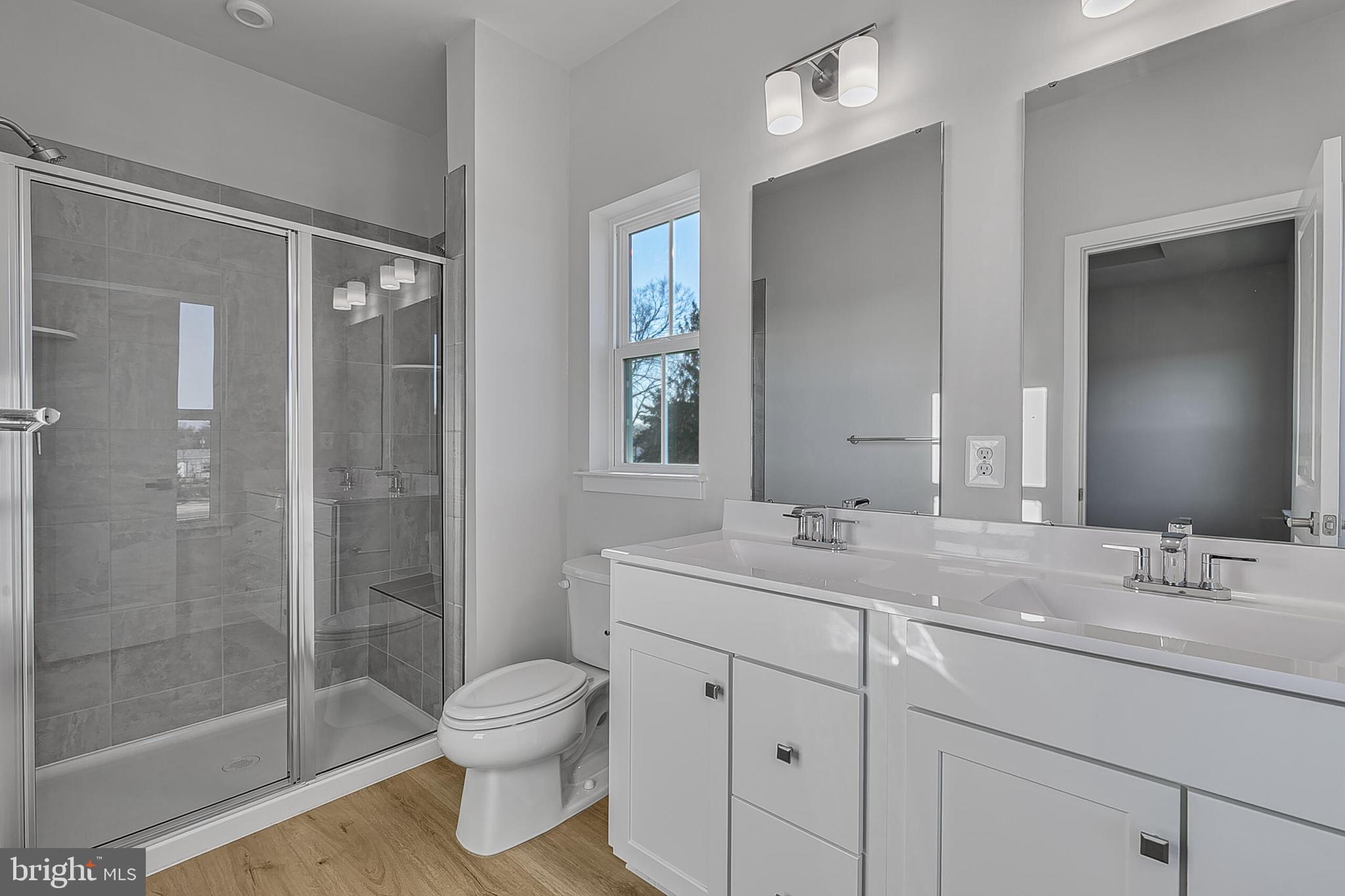 64 F Oasis Avenue Ranson, WV 25438 - Photo 38 of 39 a bathroom with a shower sink vanity mirror and toilet