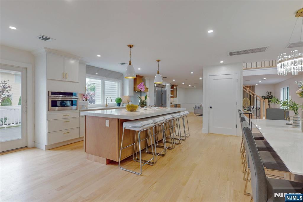 415 Bailey Road Paramus, NJ 07652 - Photo 12 of 44 a kitchen with kitchen island a counter top space a sink stainless steel appliances and cabinets