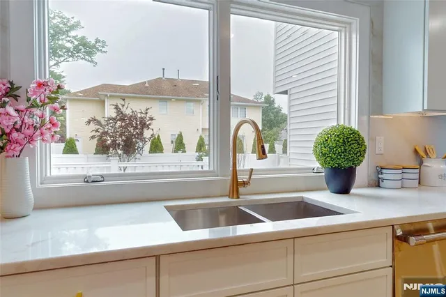 a spacious bedroom with a bed a couch and chandelier