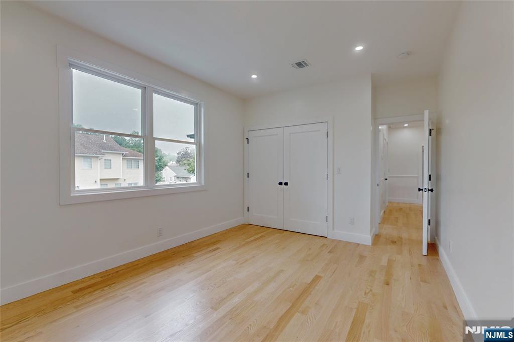 415 Bailey Road Paramus, NJ 07652 - Photo 34 of 44 a view of empty room with wooden floor and fan