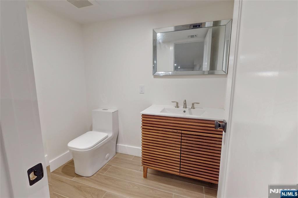 415 Bailey Road Paramus, NJ 07652 - Photo 36 of 44 a bathroom with a sink a toilet and mirror