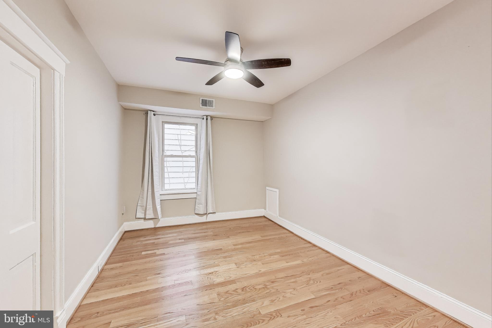 212 Elm Street Northwest Washington, DC 20001 - Photo 12 of 50 a view of an empty room with wooden floor and a window