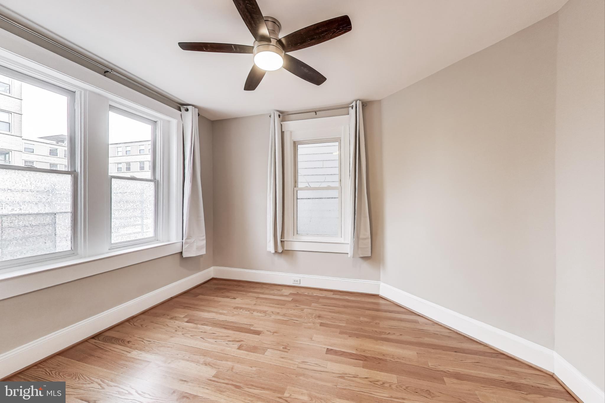212 Elm Street Northwest Washington, DC 20001 - Photo 16 of 50 a view of an empty room with wooden floor and a window