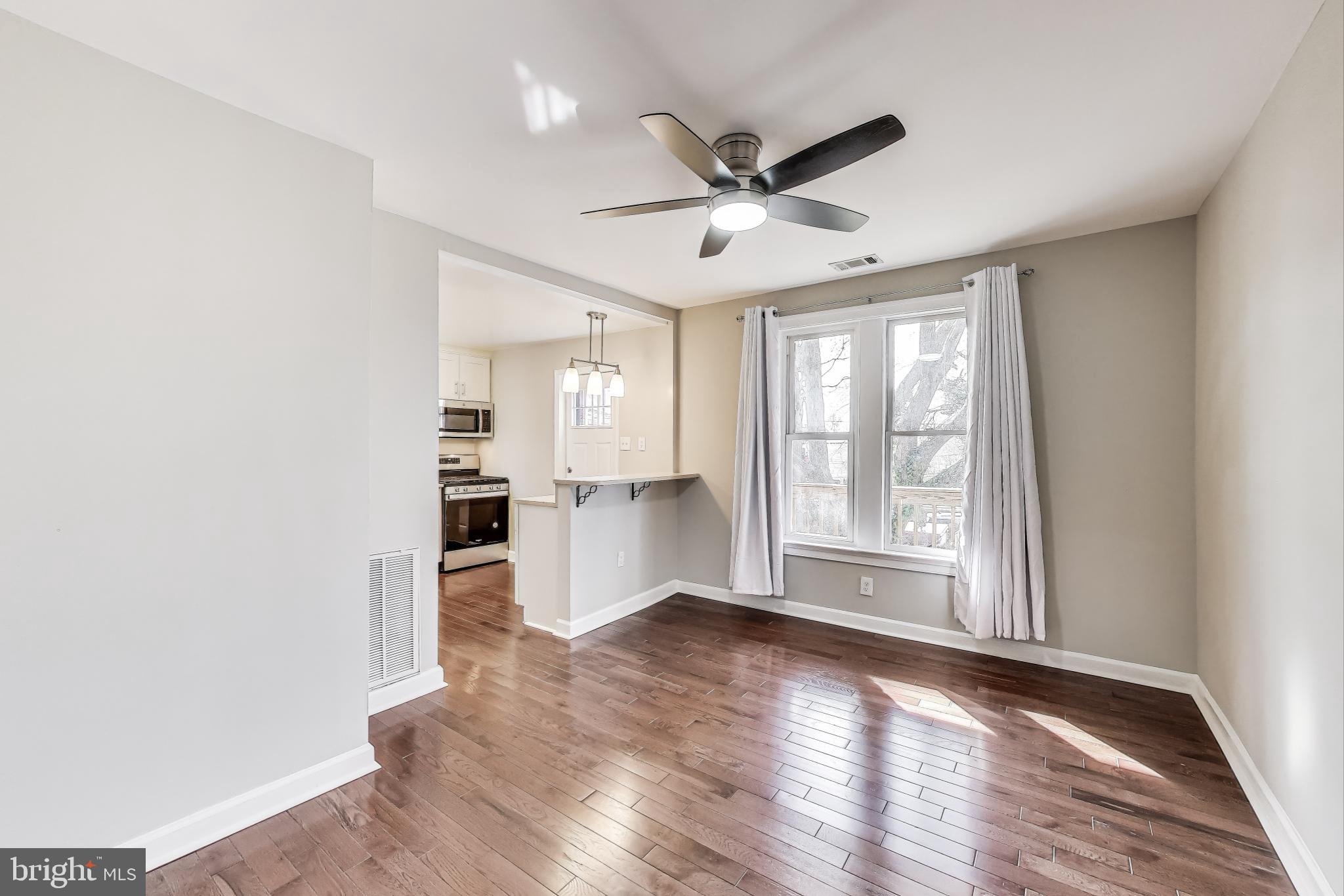 212 Elm Street Northwest Washington, DC 20001 - Photo 28 of 50 a view of empty room with wooden floor and fan