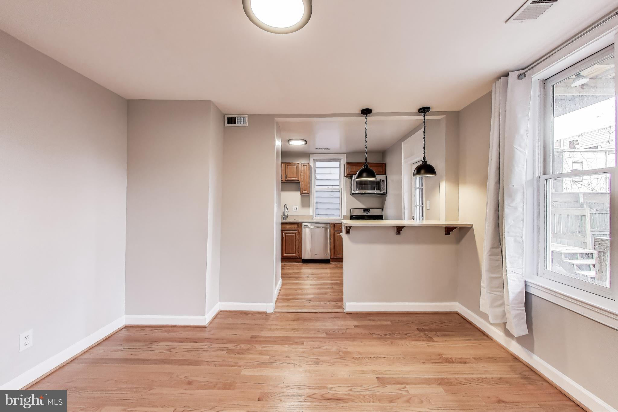 212 Elm Street Northwest Washington, DC 20001 - Photo 8 of 50 a view of a kitchen with wooden floor and a window