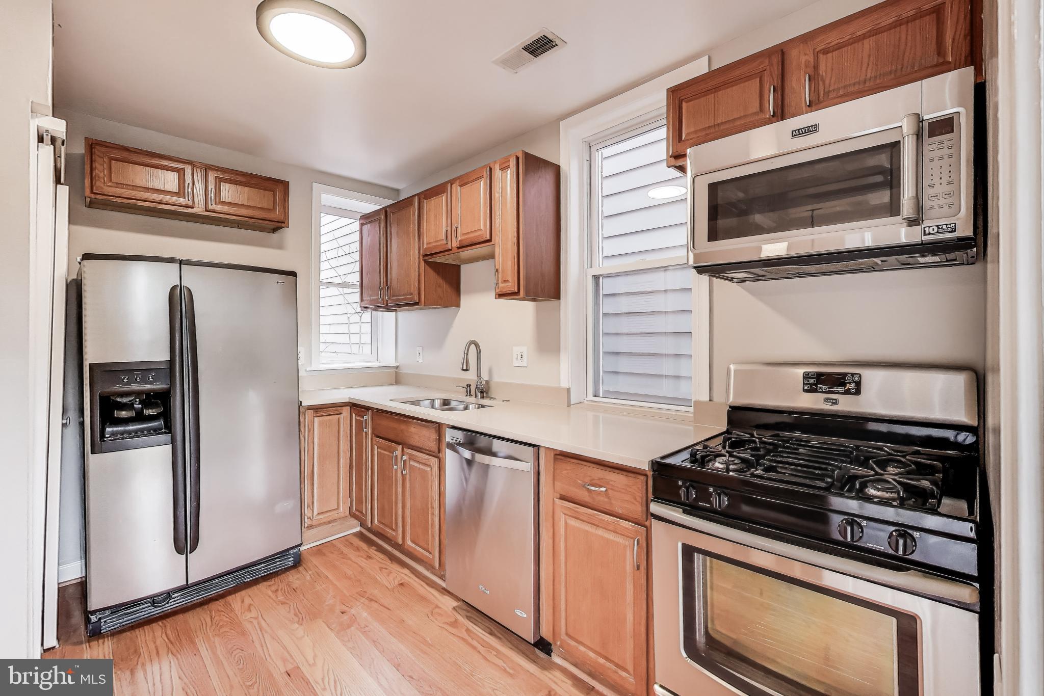 212 Elm Street Northwest Washington, DC 20001 - Photo 9 of 50 a kitchen with stainless steel appliances granite countertop a stove microwave and refrigerator