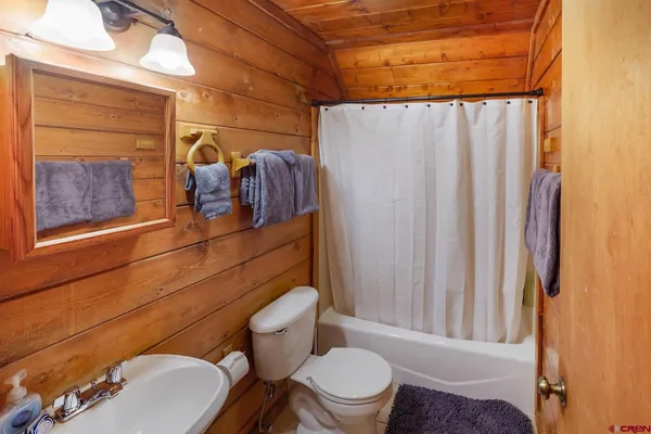 a white toilet sitting next to a bathroom sink
