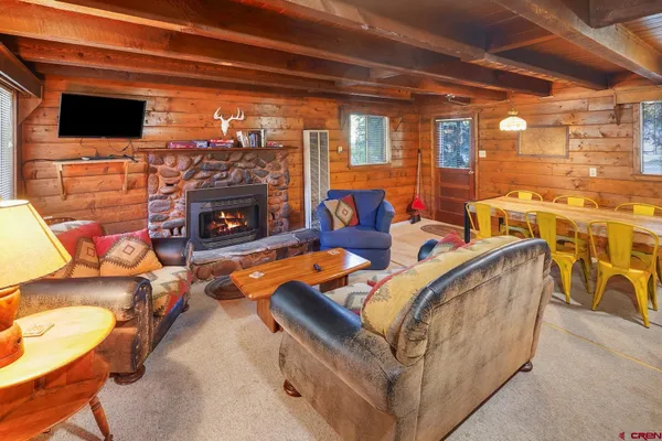 a kitchen with stainless steel appliances a stove a refrigerator sink and wooden cabinets