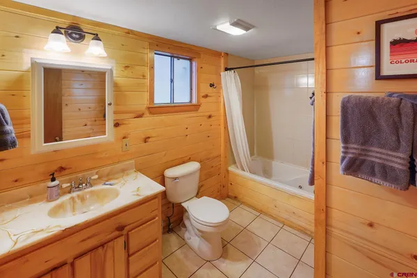 a bedroom with two beds and painting on the wall